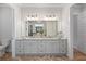 Elegant bathroom featuring a double vanity, marble countertops, and a large mirror at 1055 Amarose Ne Ln, Marietta, GA 30066