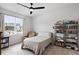 Well-lit bedroom featuring a ceiling fan, bookshelves, and a cozy reading nook by the window at 1055 Amarose Ne Ln, Marietta, GA 30066