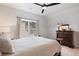 Light and airy bedroom with a neutral palette, featuring a large window and dark wood furnishings at 1055 Amarose Ne Ln, Marietta, GA 30066