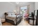 Cozy bedroom with hardwood floors, a chandelier, and a large window at 1055 Amarose Ne Ln, Marietta, GA 30066