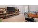 Spacious bonus room featuring bookshelves, entertainment center, a vintage table and chairs, and natural light at 1055 Amarose Ne Ln, Marietta, GA 30066