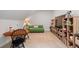 Inviting bonus room with comfortable seating, built-in bookshelves, and a vintage table and chairs at 1055 Amarose Ne Ln, Marietta, GA 30066