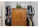 An organized closet with a traditional wood cabinet with drawers and matching clothes racks at 1055 Amarose Ne Ln, Marietta, GA 30066