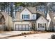 Charming two-story home with gray and white exterior, well-manicured lawn, and an attached two-car garage at 1055 Amarose Ne Ln, Marietta, GA 30066