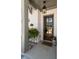 Inviting front entrance with a wood door, decorative hanging lantern, white brick, and a charming Hello doormat at 1055 Amarose Ne Ln, Marietta, GA 30066