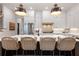 Modern kitchen with white cabinets, stainless steel appliances, large island, and stylish pendant lighting at 1055 Amarose Ne Ln, Marietta, GA 30066