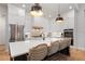 Bright and airy kitchen featuring stainless steel appliances, white cabinetry, and seating for four at the island at 1055 Amarose Ne Ln, Marietta, GA 30066
