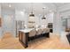 Modern kitchen featuring stainless steel appliances, white cabinetry, pendant lighting, and a black center island at 1055 Amarose Ne Ln, Marietta, GA 30066