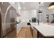 Bright kitchen featuring white cabinets, stainless steel appliances, long island, and hardwood floors at 1055 Amarose Ne Ln, Marietta, GA 30066