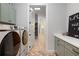 Modern laundry room with green cabinets and a full-sized washer and dryer at 1055 Amarose Ne Ln, Marietta, GA 30066