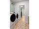 Modern laundry room with green cabinets and a full-sized washer and dryer at 1055 Amarose Ne Ln, Marietta, GA 30066