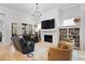 Cozy living room featuring a fireplace, built-in bookshelves, and a comfortable seating area with a chandelier at 1055 Amarose Ne Ln, Marietta, GA 30066