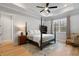 Tranquil main bedroom featuring tray ceilings, hardwood floors, and a cozy seating area at 1055 Amarose Ne Ln, Marietta, GA 30066