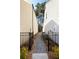 Narrow side yard with a gravel path, black fencing and landscaping at 1055 Amarose Ne Ln, Marietta, GA 30066