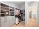 Bright walk-in closet with custom shelving and storage that leads to the spacious, modern bathroom at 1055 Amarose Ne Ln, Marietta, GA 30066
