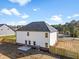A two-story home has a small backyard enclosed by a wooden fence, along with a concrete patio and an AC unit at 1599 Sungrown Way, Mcdonough, GA 30253