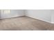 Spacious bedroom featuring neutral carpet, base trim, and bright window at 1599 Sungrown Way, Mcdonough, GA 30253