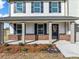 Inviting front porch with brick accents and a welcoming entrance at 1599 Sungrown Way, Mcdonough, GA 30253