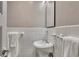 Bright bathroom with white tile, sleek pedestal sink, and a minimalist mirror at 300 Peachtree Ne St # 6H, Atlanta, GA 30308