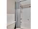 Bathroom featuring a white bathtub and shower with a gray shower curtain and a tiled wall at 300 Peachtree Ne St # 6H, Atlanta, GA 30308
