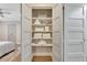 Open linen closet with neatly arranged towels, toiletries, and other essentials on shelves at 300 Peachtree Ne St # 6H, Atlanta, GA 30308