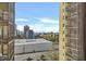 City view from condo featuring high-rise buildings and tree coverage below blue skies at 300 Peachtree Ne St # 6H, Atlanta, GA 30308
