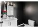 Stylish half bath with a modern vanity, elegant mirror, and contemporary black walls at 3933 Danube Ln # 221, Atlanta, GA 30339