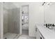 An elegant bathroom features a glass-enclosed shower and view to the bedroom, seamlessly blending style and functionality at 3933 Danube Ln # 221, Atlanta, GA 30339