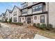 Charming multi-story building featuring a light brick facade, black-trimmed windows and manicured landscaping at 3933 Danube Ln # 221, Atlanta, GA 30339