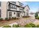 Charming multi-story building featuring a light brick facade, black-trimmed windows and manicured landscaping at 3933 Danube Ln # 221, Atlanta, GA 30339