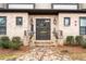 Inviting front entrance with brick walkway, well-manicured bushes, and dark trim at 3933 Danube Ln # 221, Atlanta, GA 30339