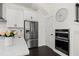 Modern kitchen features stainless steel appliances, white cabinetry, and quartz countertops at 3933 Danube Ln # 221, Atlanta, GA 30339