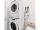 A modern stacked washer and dryer in a well-lit laundry area, offering convenience and space-saving design at 3933 Danube Ln # 221, Atlanta, GA 30339