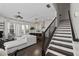 Open-concept living area with stairs, modern furnishings, and plenty of natural light at 3933 Danube Ln # 221, Atlanta, GA 30339