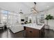 Bright living room with modern light fixtures, white furniture, and large windows at 3933 Danube Ln # 221, Atlanta, GA 30339