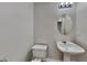 Clean half bathroom featuring a pedestal sink and modern lighting at 4928 Bryant Dr, Snellville, GA 30039