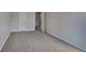 A cozy carpeted bedroom with neutral walls and a door leading to the hallway at 4928 Bryant Dr, Snellville, GA 30039