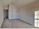 Bedroom featuring vaulted ceiling, carpeted floor, light color walls, and view of open door at 4928 Bryant Dr, Snellville, GA 30039