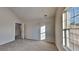 A light-filled bedroom with vaulted ceilings, carpet, and a view from the window at 4928 Bryant Dr, Snellville, GA 30039
