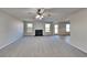 Spacious living room with a fireplace, ceiling fan, and neutral carpeting at 4928 Bryant Dr, Snellville, GA 30039