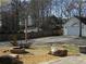 Backyard featuring a stone patio, fire pit, and a detached garage, great for outdoor entertaining at 561 Old Loganville Rd, Loganville, GA 30052
