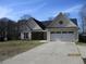 Charming single-story home features a two-car garage, well-manicured lawn, and inviting curb appeal at 561 Old Loganville Rd, Loganville, GA 30052