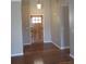Entryway with wood-look flooring and natural wood door with sidelights at 561 Old Loganville Rd, Loganville, GA 30052