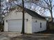 Detached garage with white siding, black roof, and a large door, providing ample space for parking and storage at 561 Old Loganville Rd, Loganville, GA 30052
