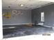 Spacious garage interior featuring gray walls, a finished floor, bright lighting, and a window at 561 Old Loganville Rd, Loganville, GA 30052