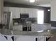 Modern kitchen boasts stainless steel appliances, white cabinets, and beautiful light countertop at 561 Old Loganville Rd, Loganville, GA 30052