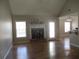 Bright living room with hardwood floors, fireplace, and a seamless flow to the dining area at 561 Old Loganville Rd, Loganville, GA 30052