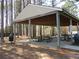 Outdoor pavilion with picnic tables, perfect for gatherings, and shaded by tall trees in a park setting at 561 Old Loganville Rd, Loganville, GA 30052