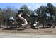 Playground with multiple slides and climbing structures surrounded by a black metal fence at 561 Old Loganville Rd, Loganville, GA 30052