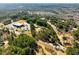 An aerial view shows a mobile home in a heavily wooded neighborhood at 1515 Ozora Rd, Loganville, GA 30052